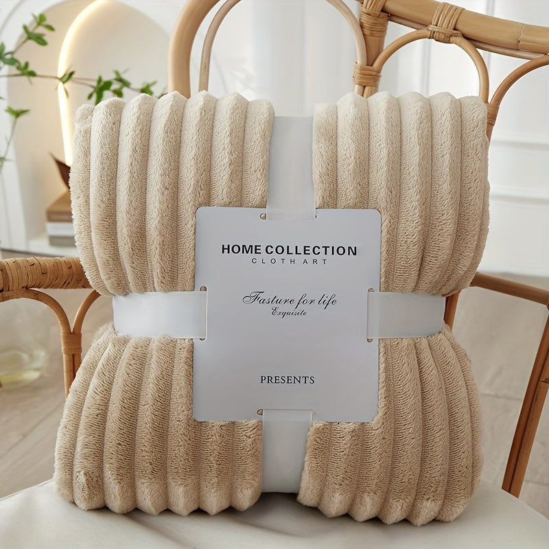 Beige textured throw blanket with a label on a chair