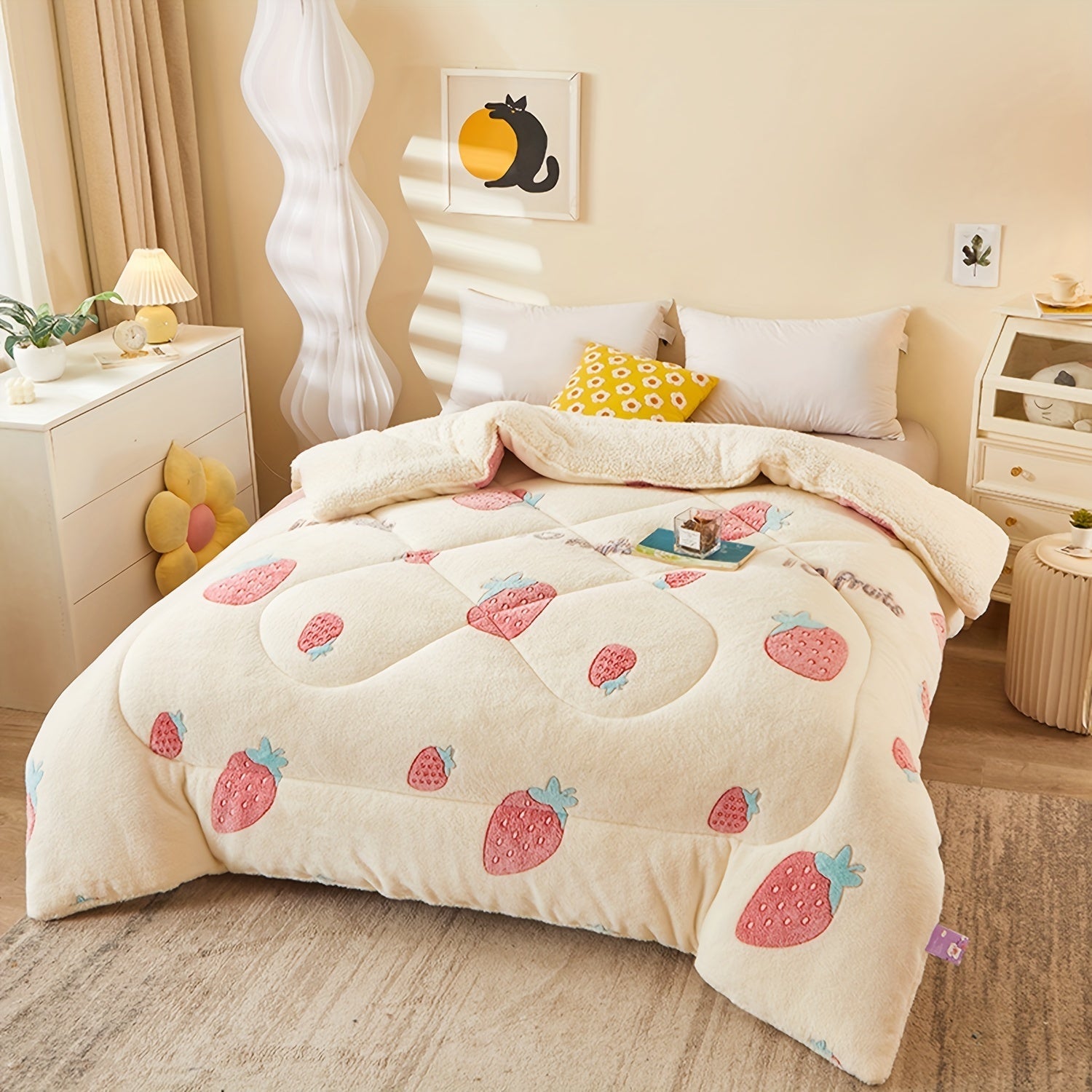 Bed with strawberry patterned comforter in a bedroom setting