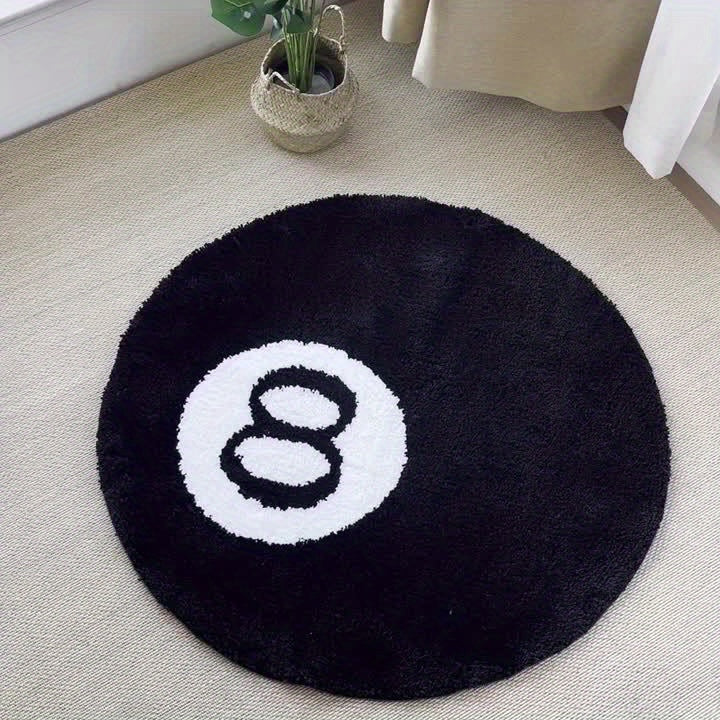Black round rug with a white number 8 design on a beige carpet.