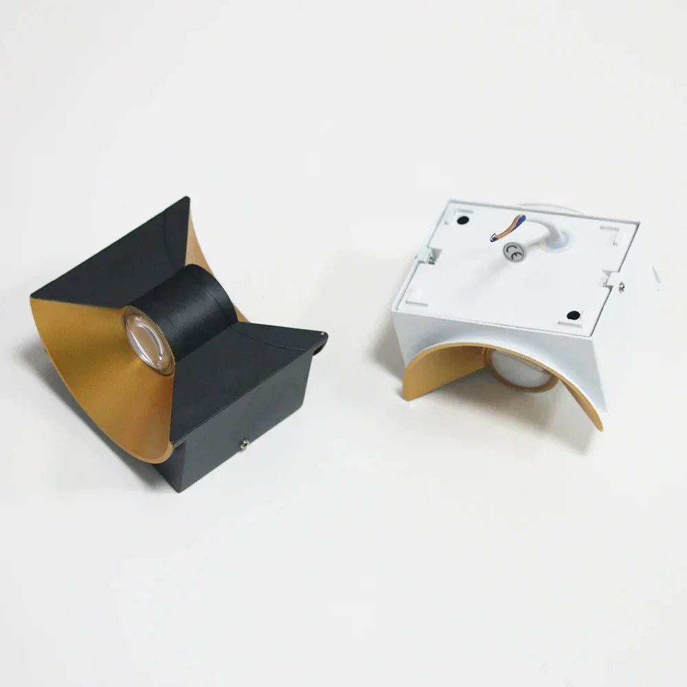 Two modern wall lights with black and gold design on a white background