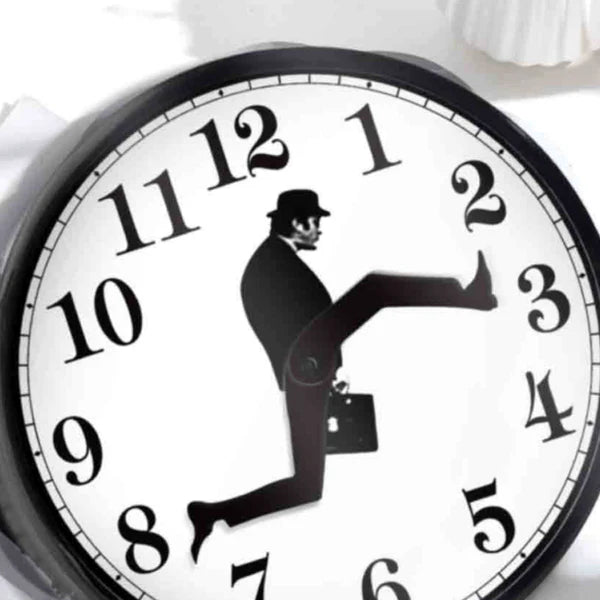 Clock with a silhouette of a man kicking another man, symbolizing time and violence.