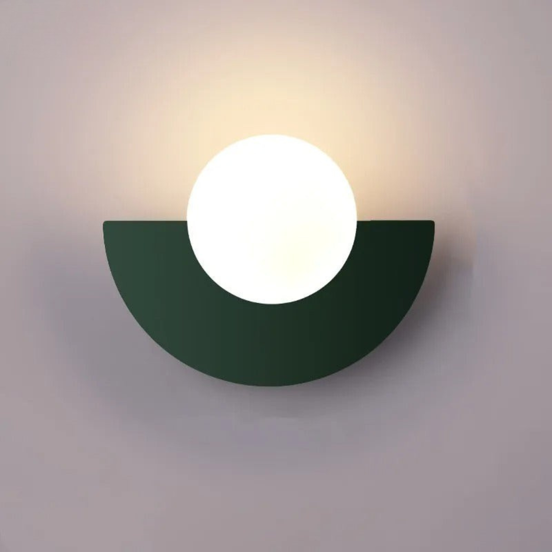 Wall-mounted light fixture with a green semi-circular base on a gray background