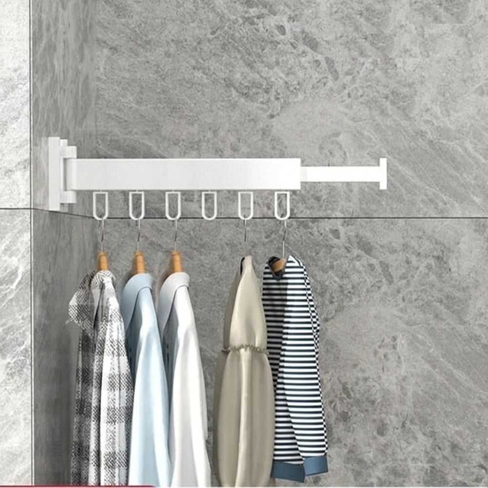 Wall-mounted clothes rack with hanging clothes against a gray marble wall.