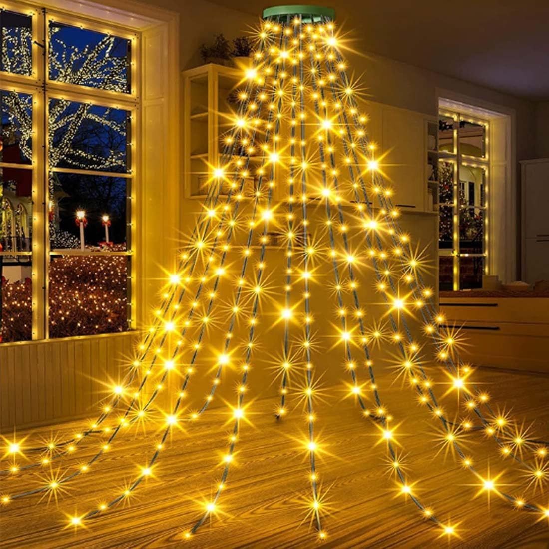 Decorative string lights arranged to resemble a Christmas tree in a room with a window.