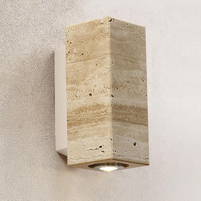 Cement wall sconce light fixture on a textured wall