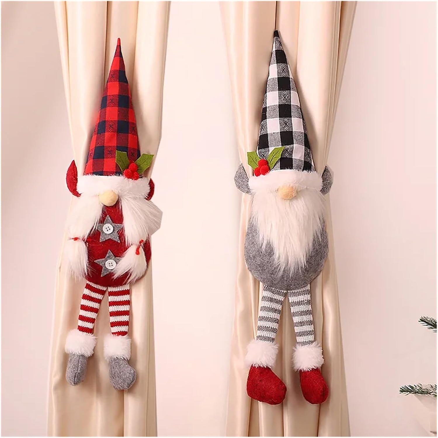 Two decorative gnomes with plaid hats hanging on a curtain.