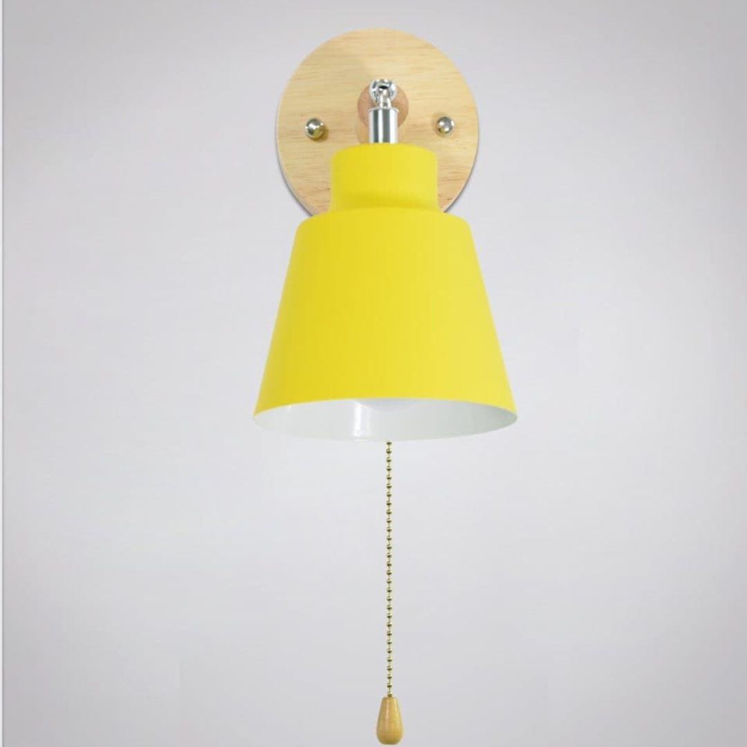 Yellow wall lamp with wooden pull chain on a light gray background