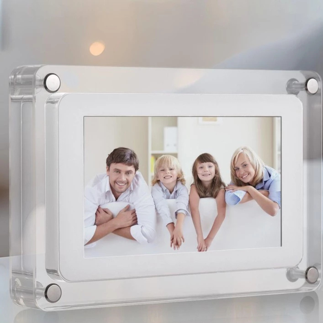 Digital photo frame displaying a family photo on a reflective surface