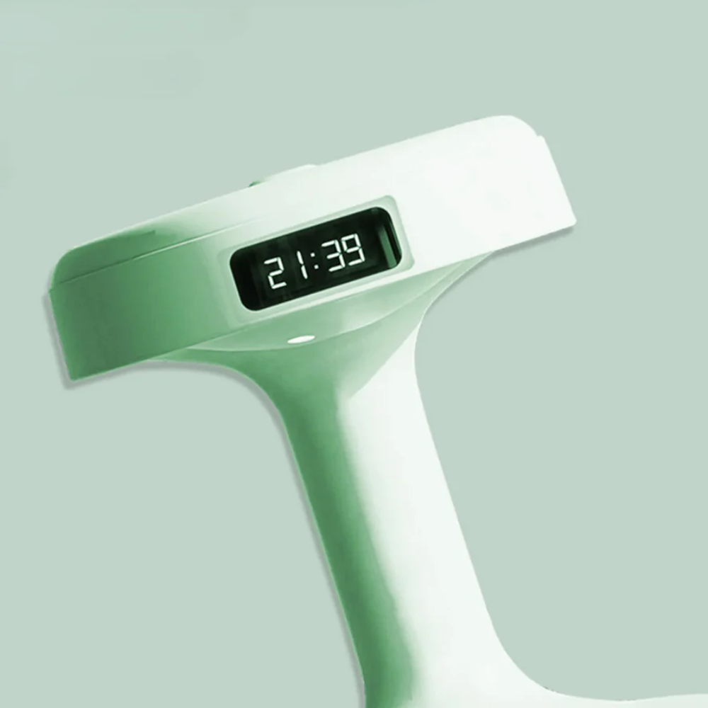 Digital clock with a green casing on a light gray background