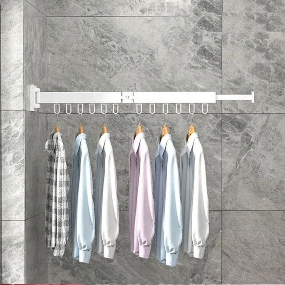 Wall-mounted clothes rack with hanging clothes against a tiled wall.