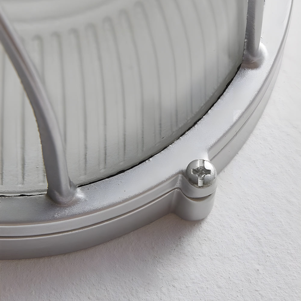 Close-up of a metallic object with a screw on a white background