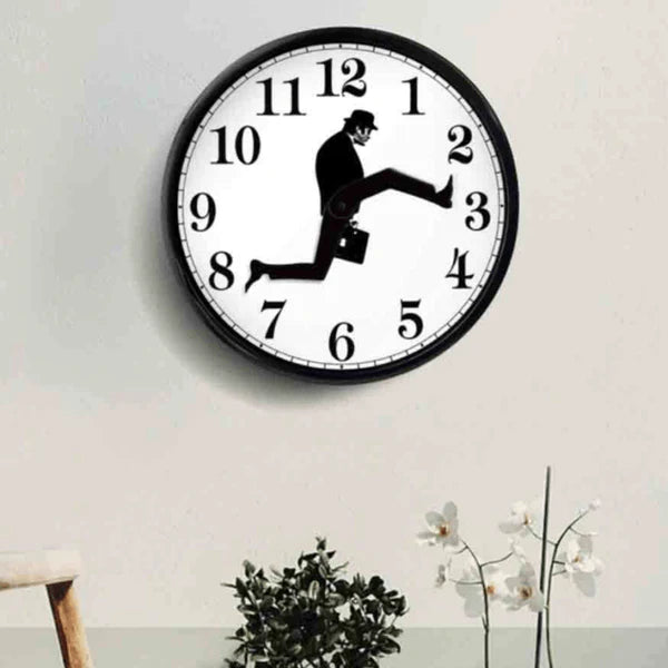 Wall clock with a design of a man running with a briefcase on a white wall.