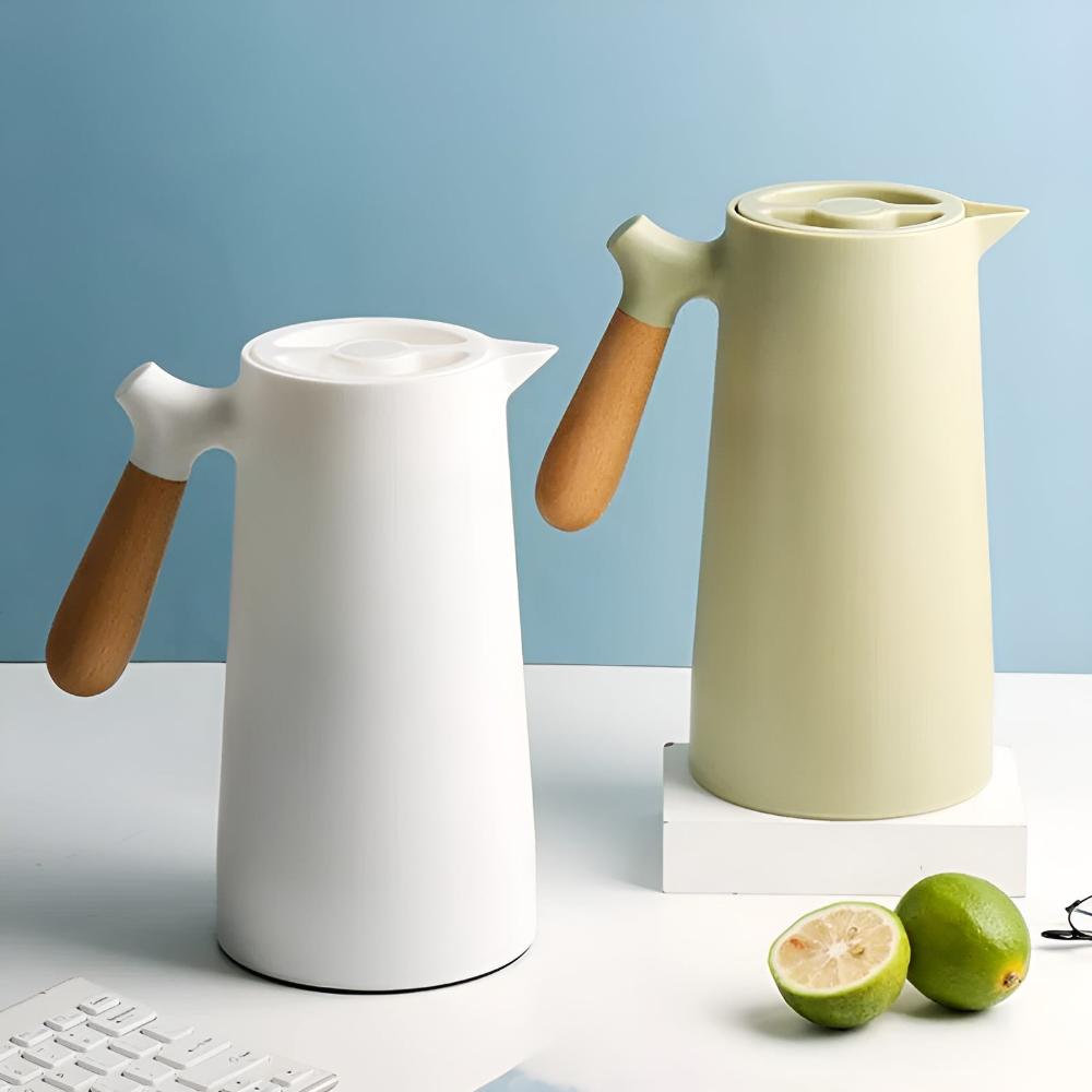 Two ceramic pitchers with wooden handles on a light blue background