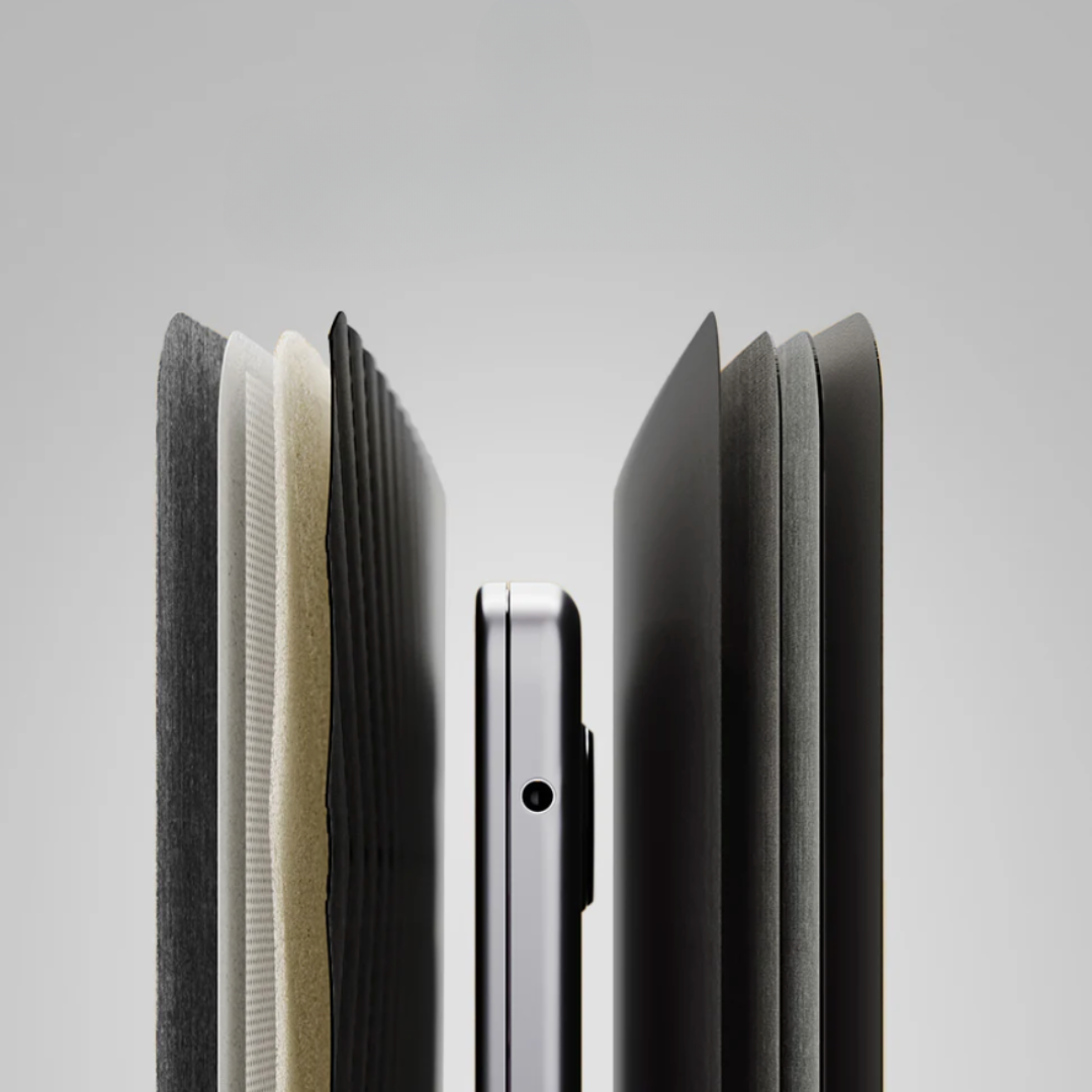 Close-up of a smartphone with a black case on a light gray background