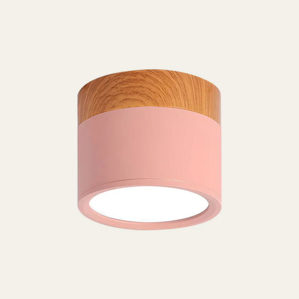 Ceiling light fixture with pink shade and wooden top on a beige background