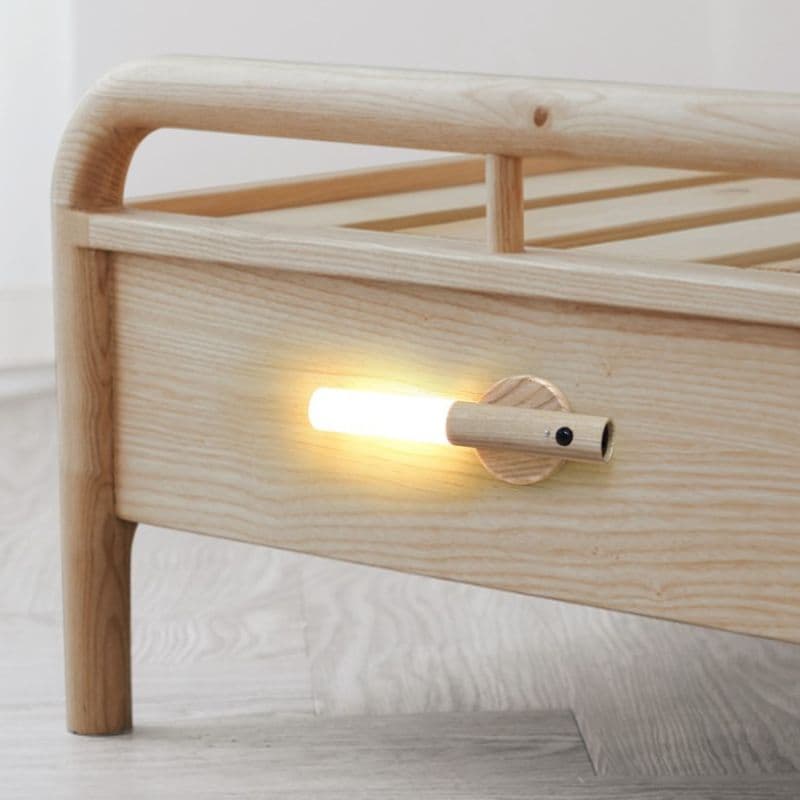 Wooden nightstand with a built-in wall-mounted light fixture.