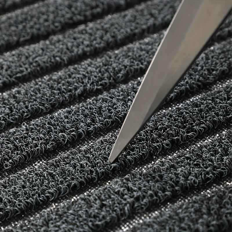 Close-up of a textured black surface with a sharp object on top