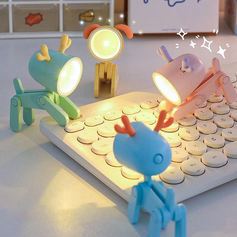 Four colorful animal-shaped lamps on a keyboard with a white background
