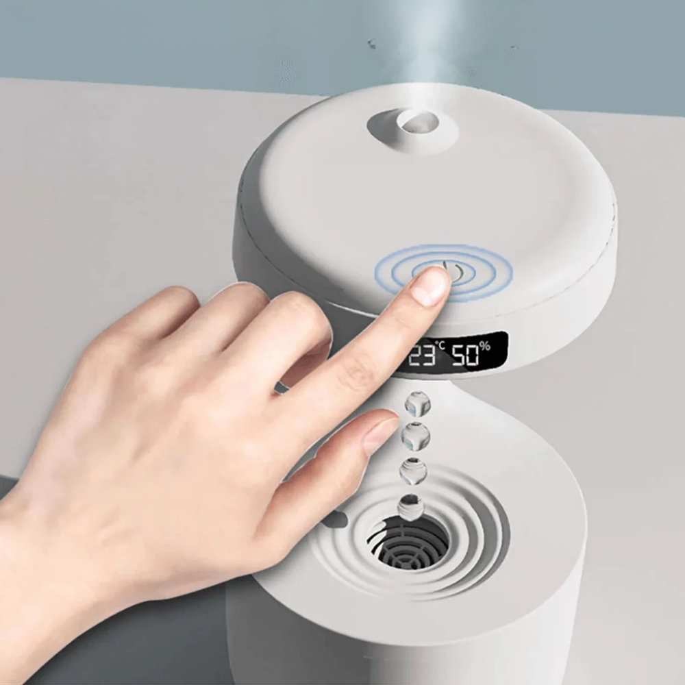 Hand pressing a digital display on a white electronic device with a gray background