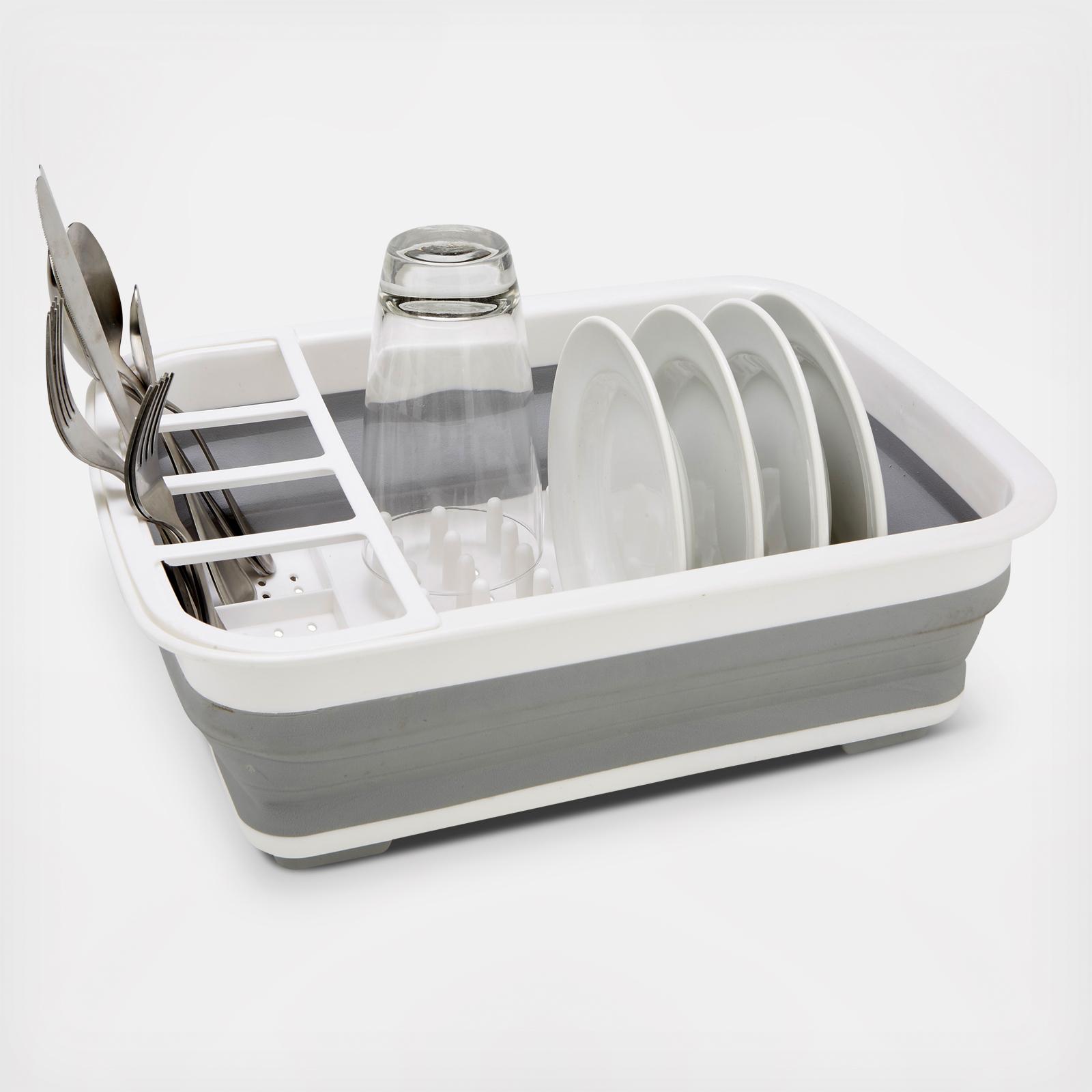 Collapsible dish rack with dishes on a white background