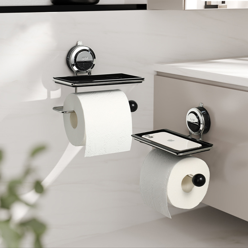 Bathroom wall-mounted toilet paper holder with two rolls of toilet paper on a white wall.