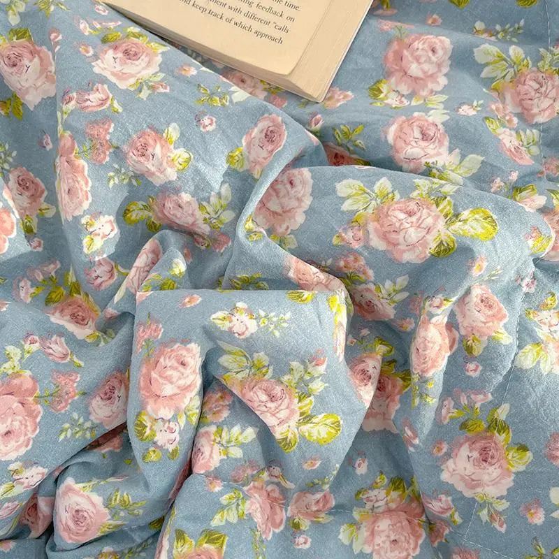 Floral fabric with pink roses on a blue background