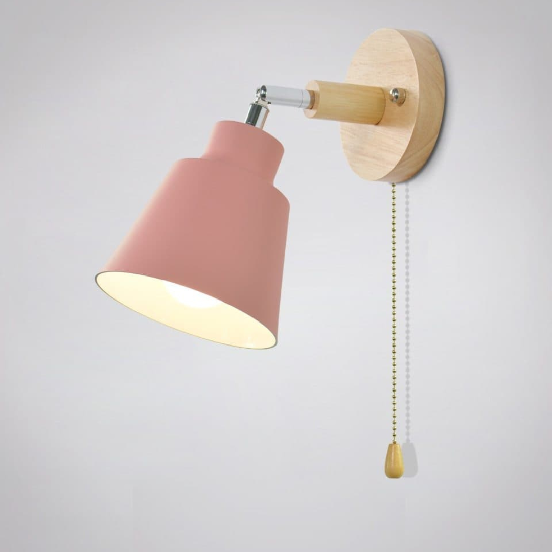 Wall-mounted lamp with pink shade and wooden fixture on a light gray background