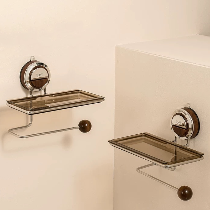 Two wall-mounted glass shelves with metal brackets on a beige wall.