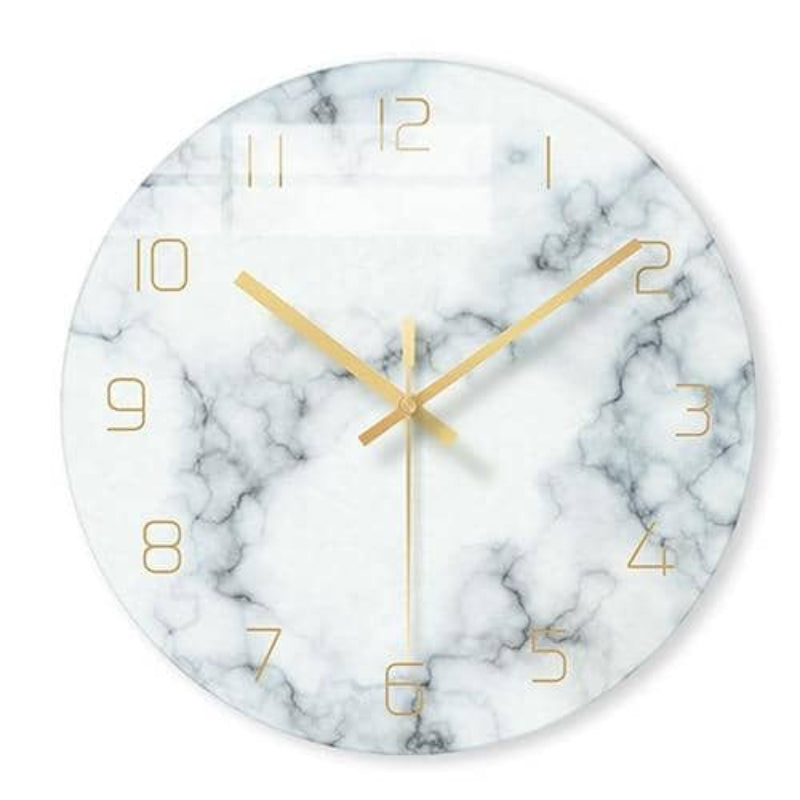 Marble-patterned wall clock with gold hands on a white background