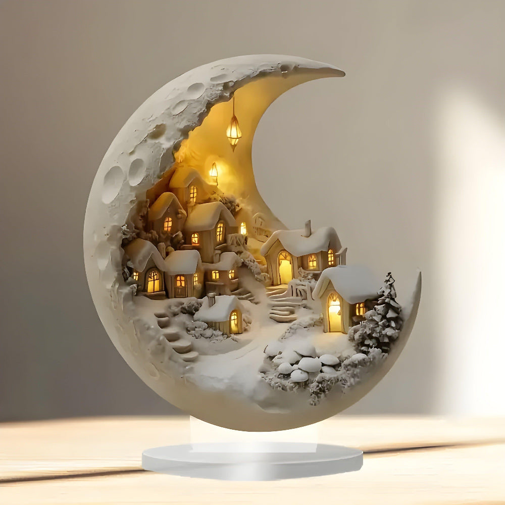 Decorative moon-shaped lamp with a snowy village inside, on a neutral background