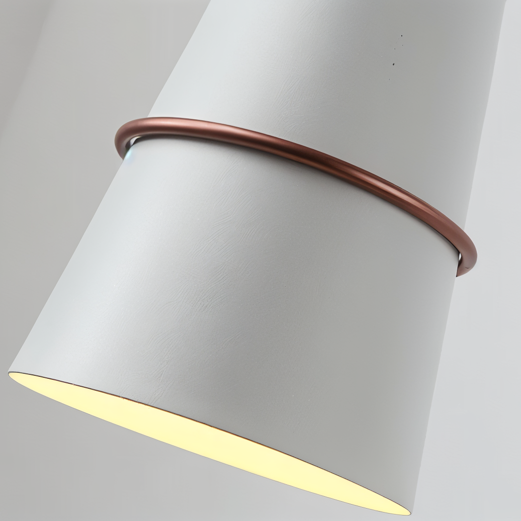 Cylindrical light fixture with a copper band on a gray background