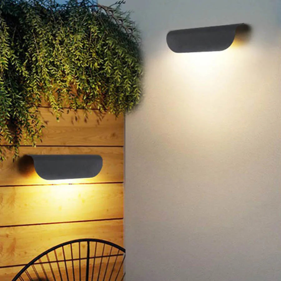 Outdoor wall lights on a wooden planter and white wall
