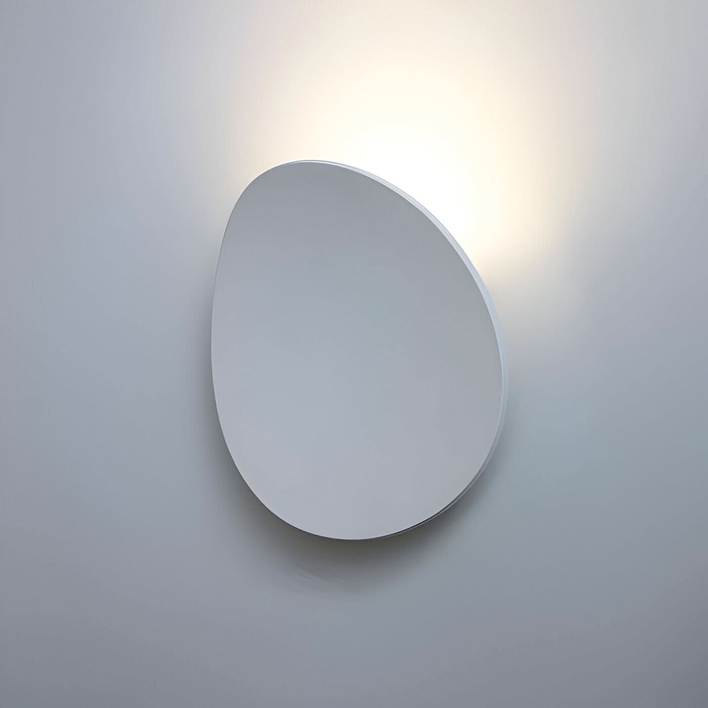 Modern wall-mounted mirror with a light fixture on a gray background