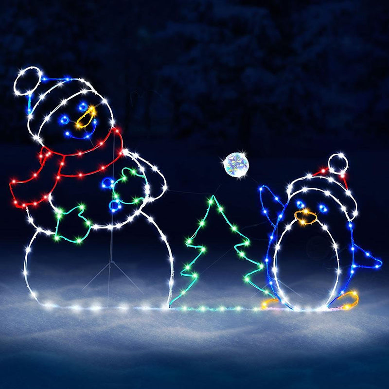 Decorative lights shaped like a snowman and penguin with a Christmas tree on a dark background.