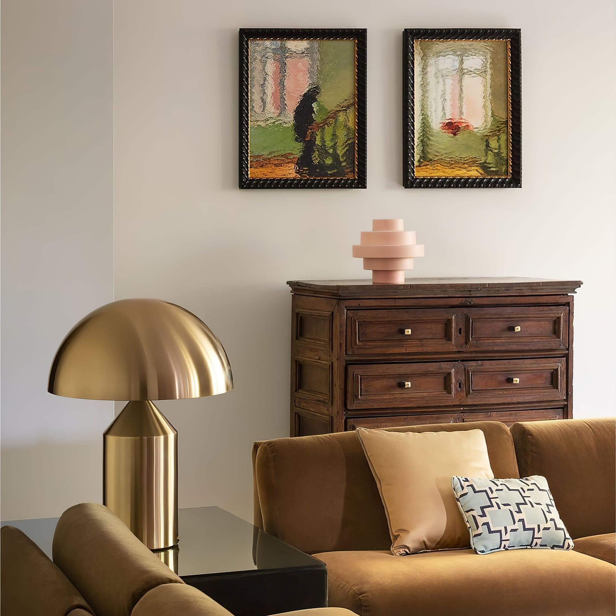 Living room with brown sofa, gold lamp, wooden dresser, and framed artwork.
