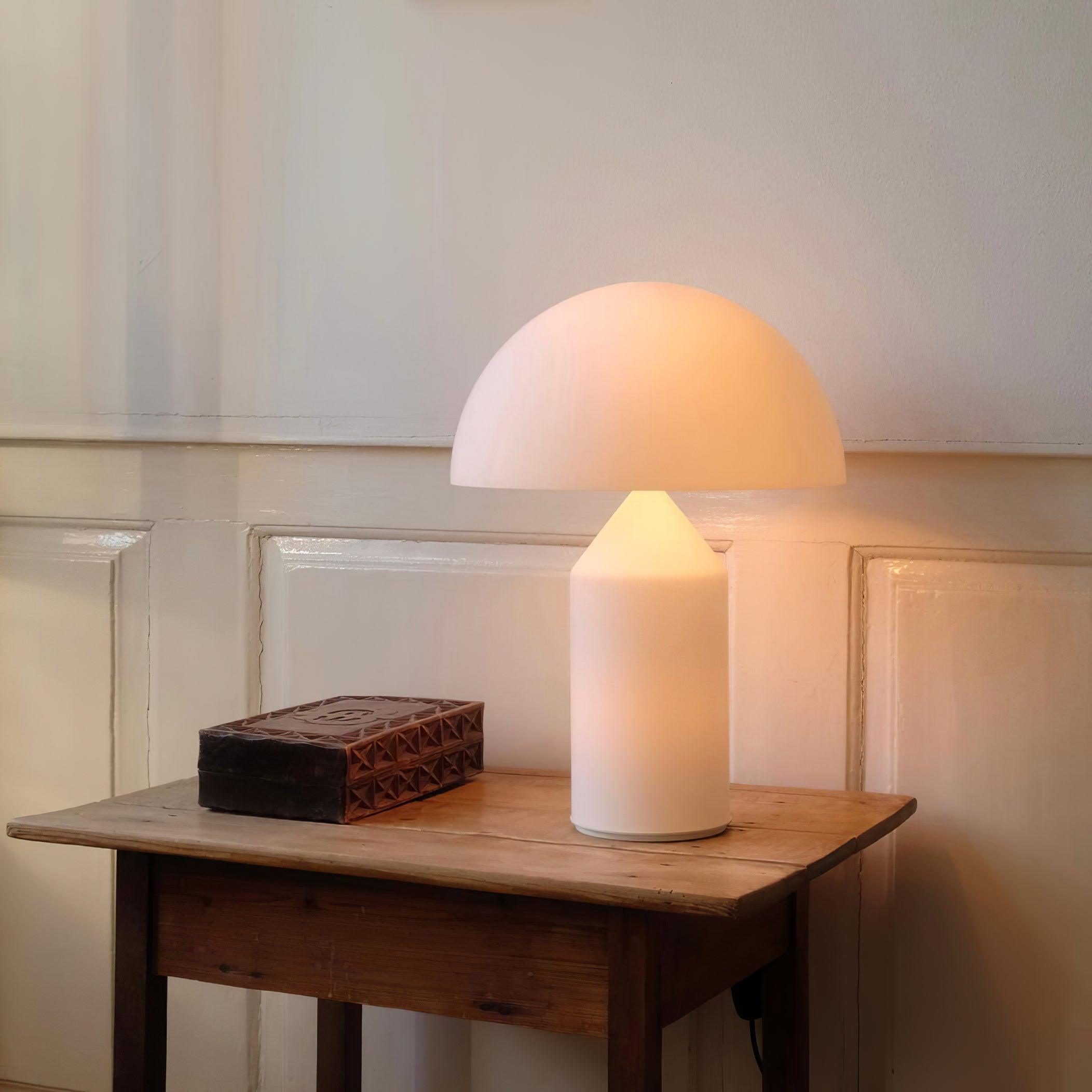 White table lamp on a wooden side table with a neutral wall background
