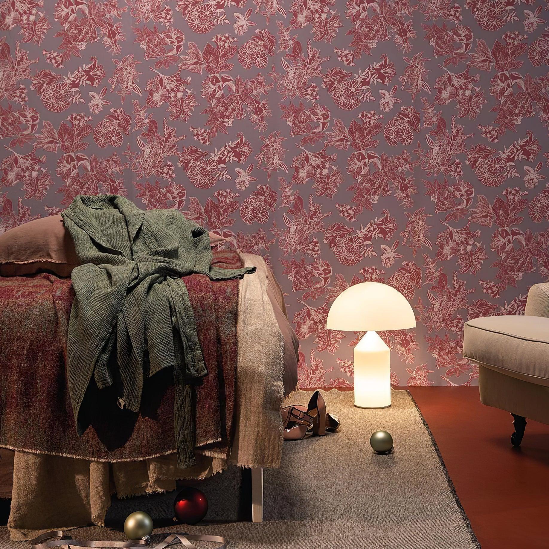 Room interior with floral wallpaper, bed, lamp, and chair.