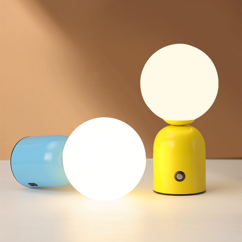Two colorful table lamps with glowing white lights on a beige background