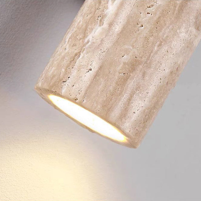 Cylindrical light fixture with a textured surface on a gray background