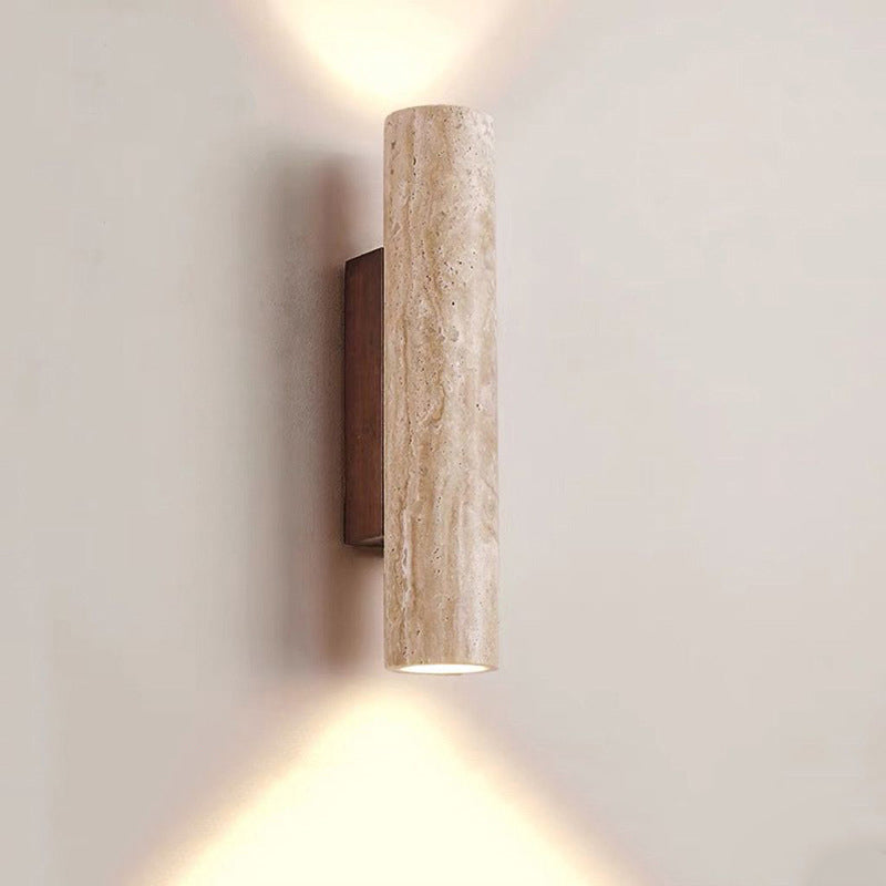 Cylindrical wall light fixture on a plain wall