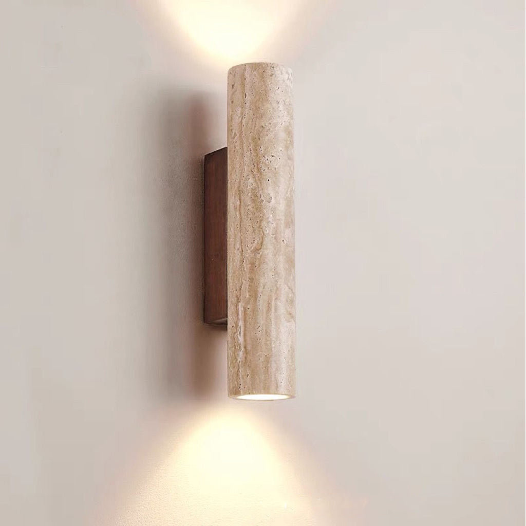 Wall-mounted cylindrical light fixture on a plain wall