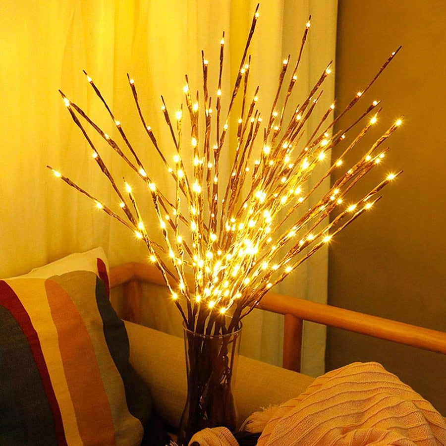 Decorative lighting arrangement with LED lights in a vase on a couch.