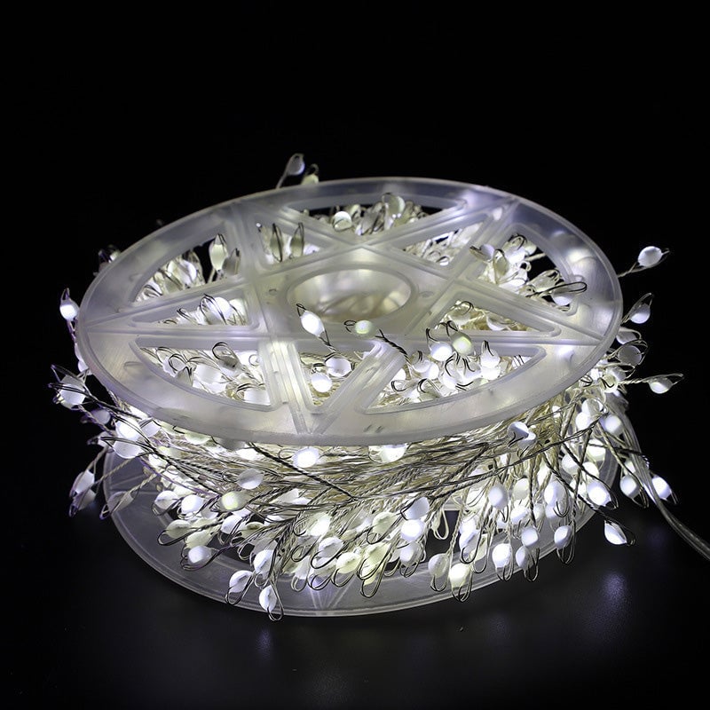 Roll of LED string lights on a black background