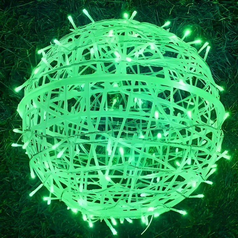 Green LED string light ball on a grass background