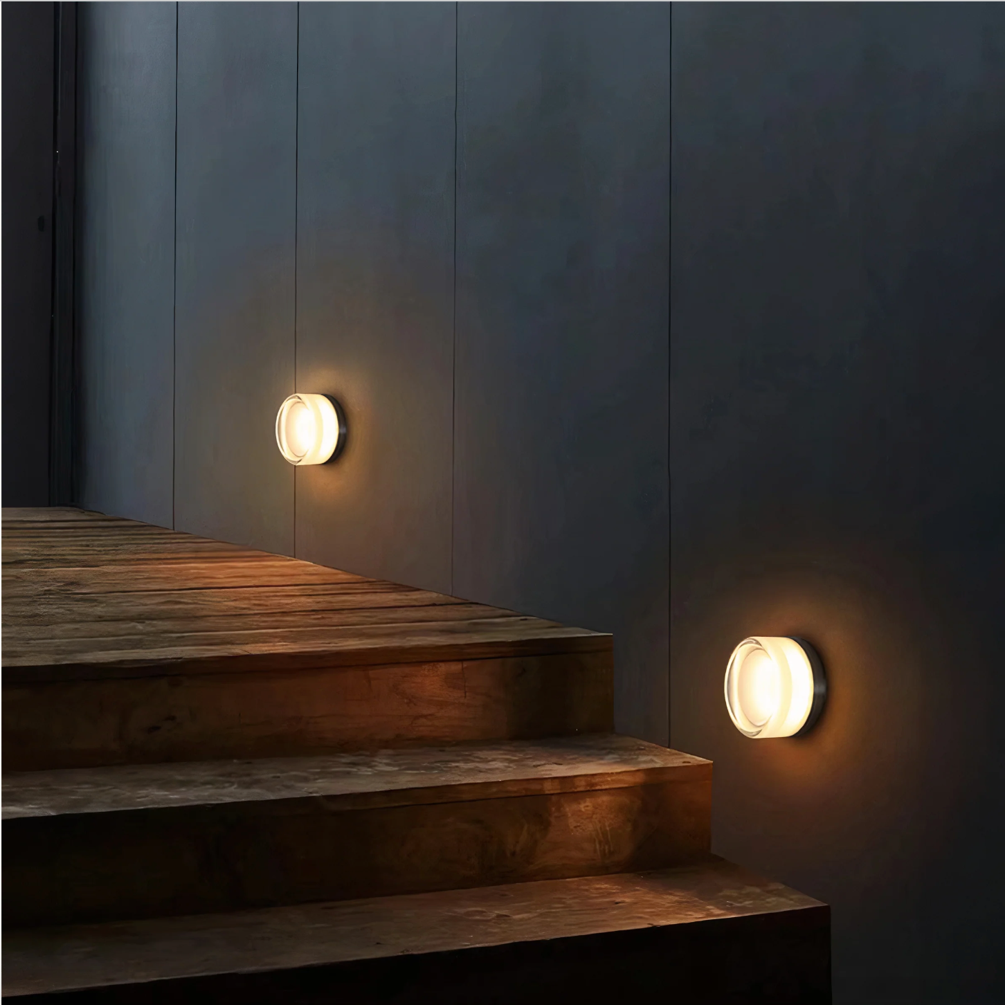 Round wall light fixture on a textured wall on outdoor area