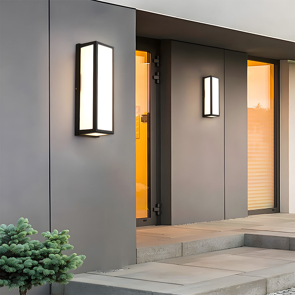 Modern outdoor wall lights on a gray building facade with steps and plants.