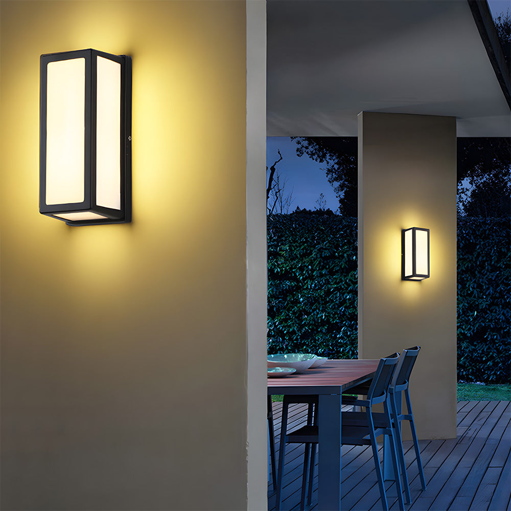 Outdoor wall lights on a house exterior with a patio area in the background.