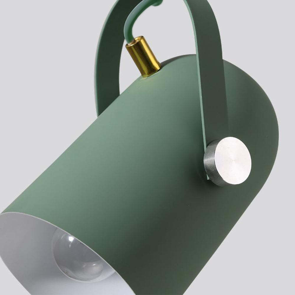 Green cylindrical light fixture with gold and silver accents on a light gray background