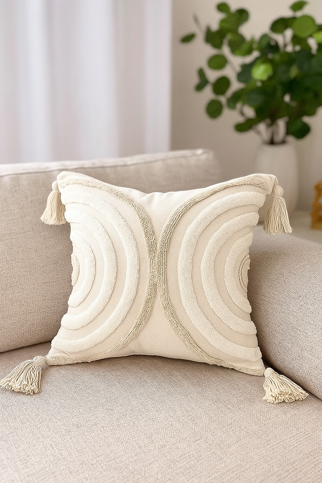 Decorative pillow with tassels on a beige sofa