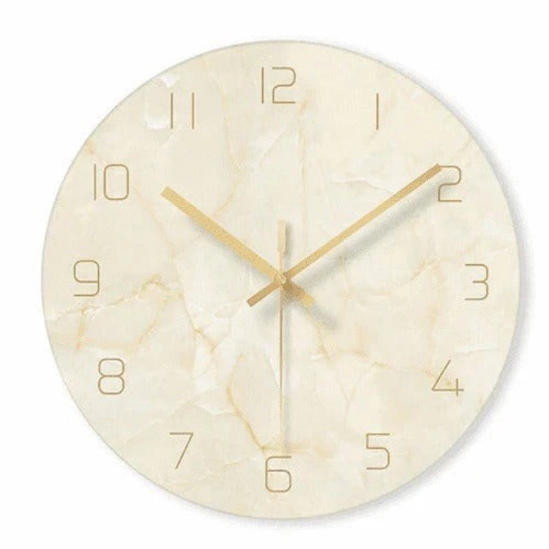 Round wall clock with beige marble pattern and gold hands on a white background